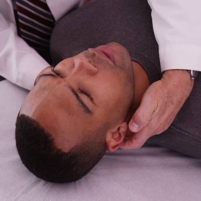 Man getting his neck examined by chiropractor